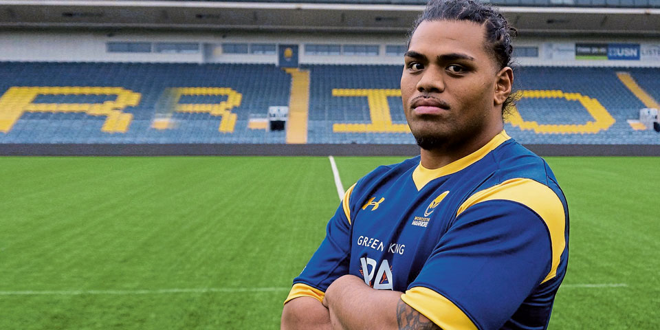 joe taufetee standing on worcester warrior's pitch with his arms folded
