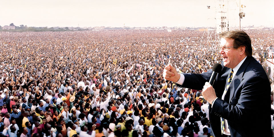 Reinhard Bonnke preaching to a huge crowd of people
