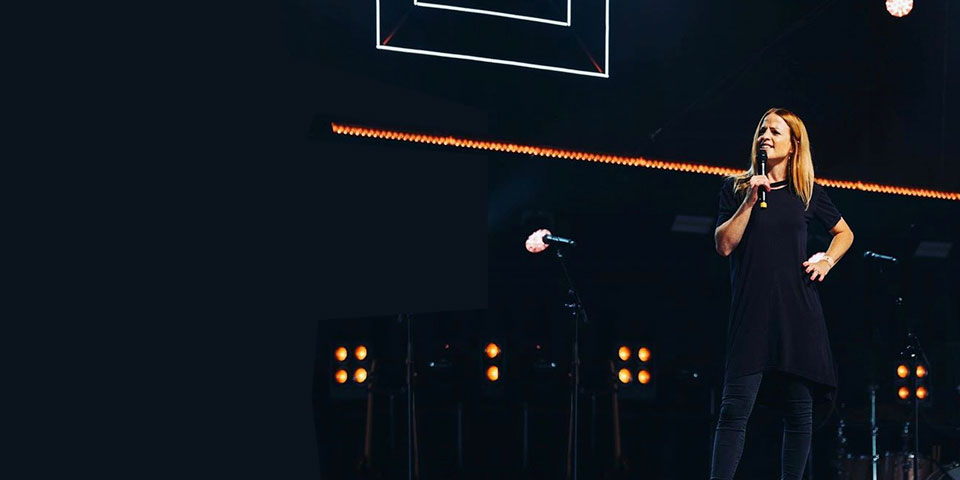 Rachel Gardner standing on a stage as she speaks